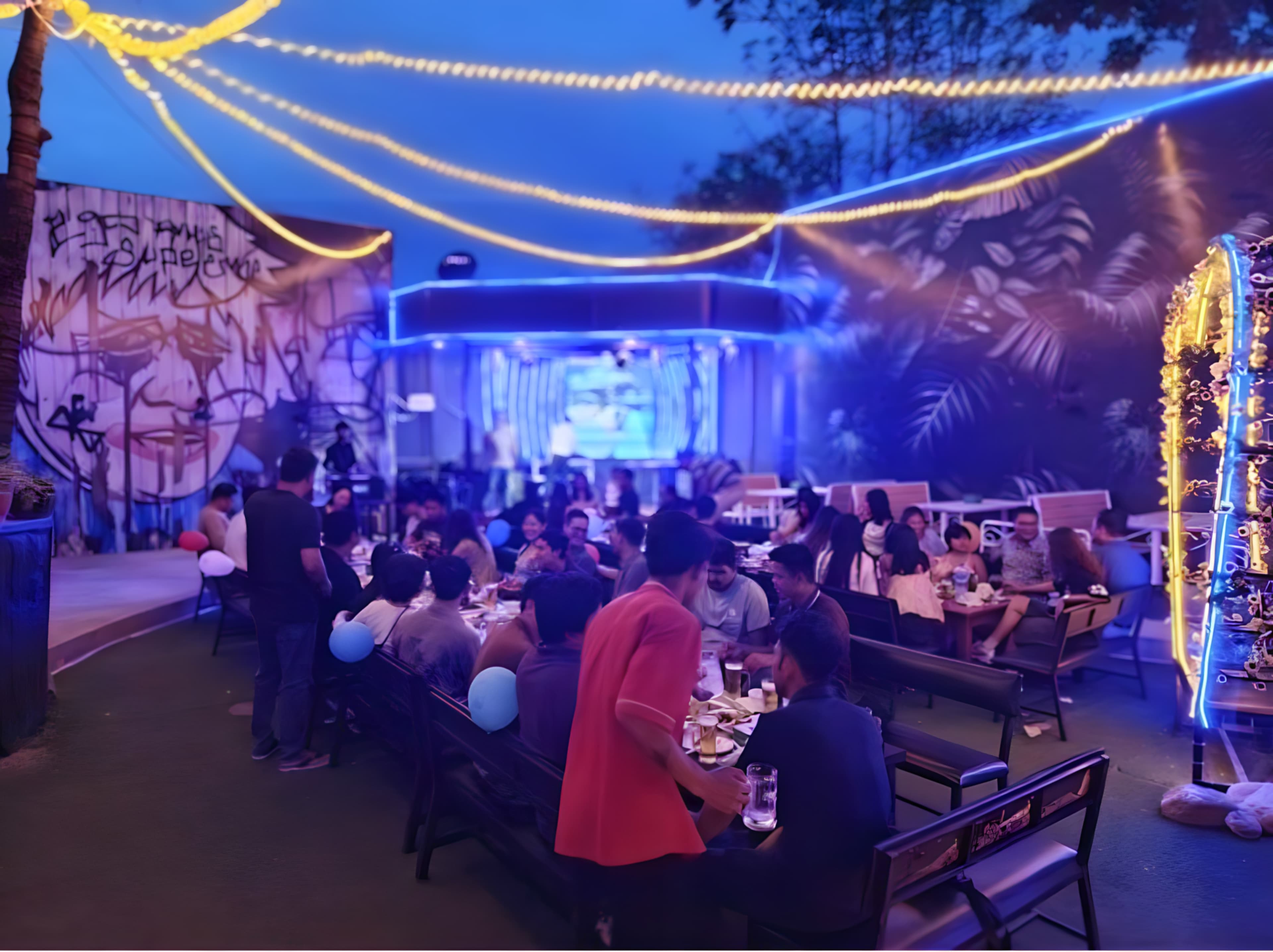 Evening event under string lights at UN Bar & Garden