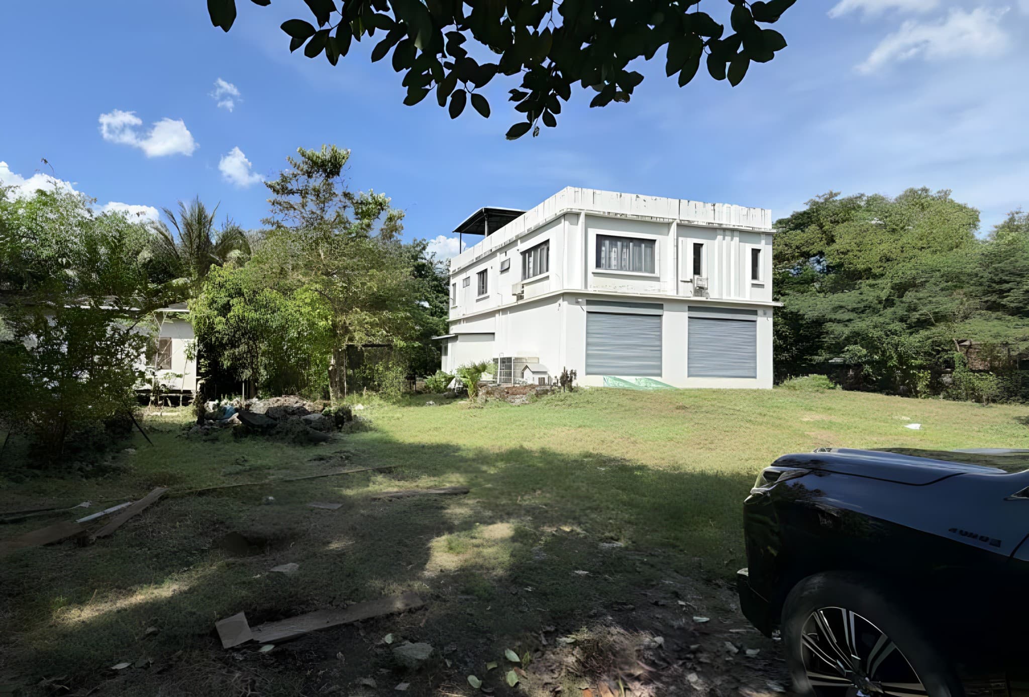 Two-story building on an open grass lot