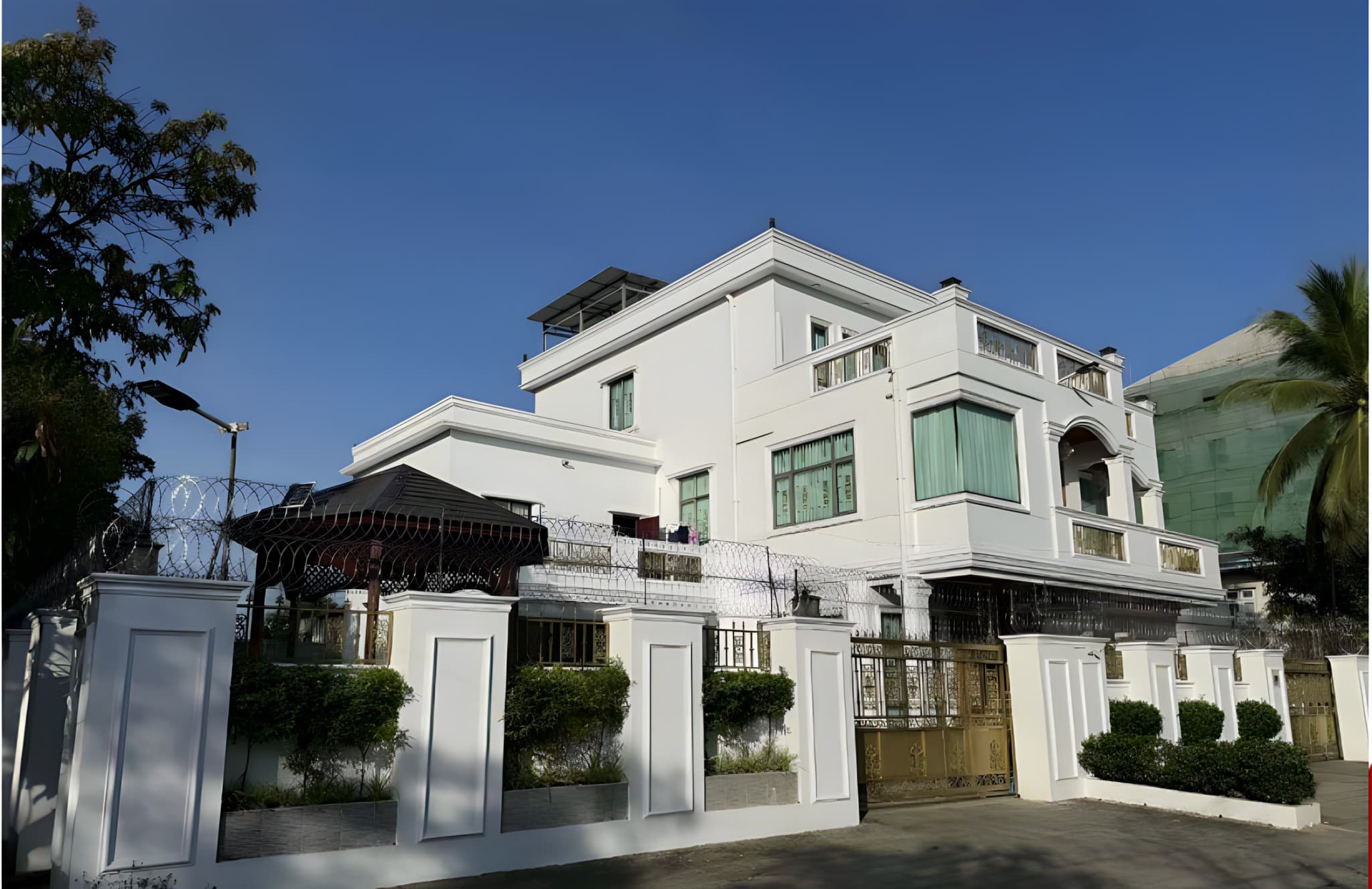 White villa with an ornate gate