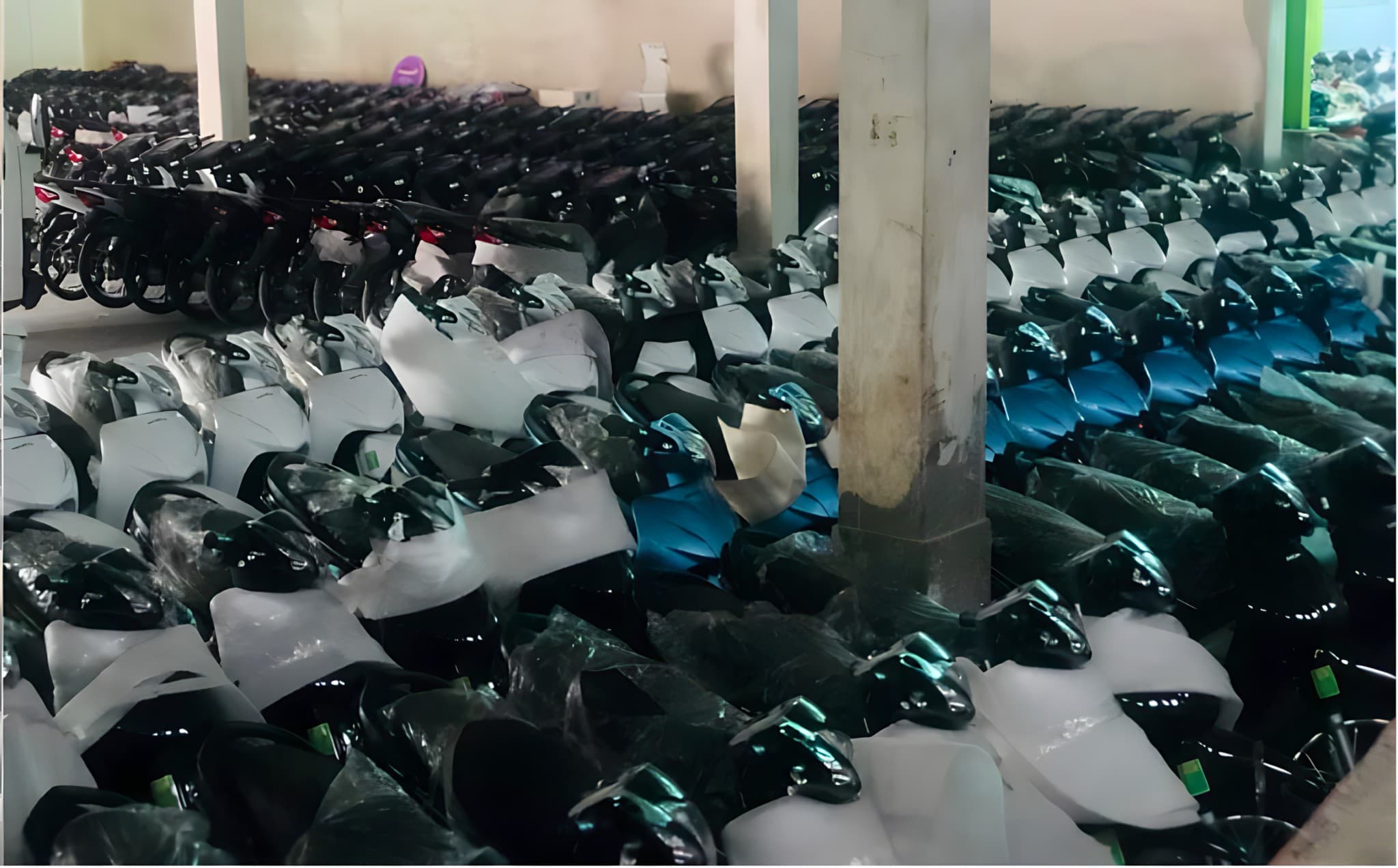 Rows of motorcycles in assorted colors in the warehouse